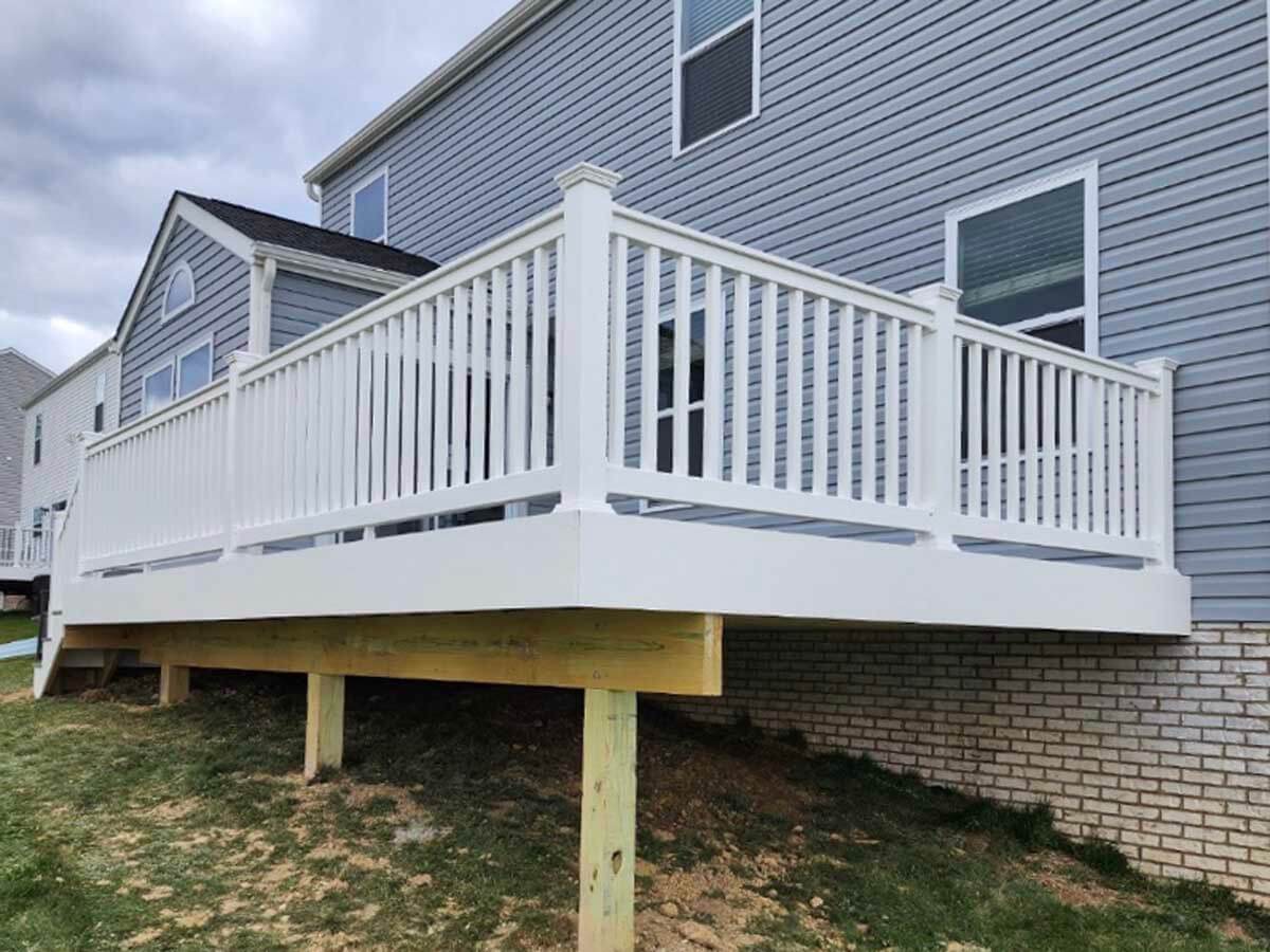 Deck with vinyl railings installed on the front of a home in Ohio